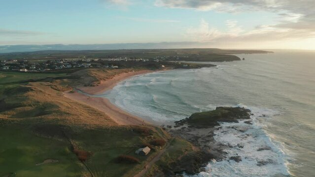 Aerial view of Constantine Bay at sunset during hightide, Cornwall, United Kingdom.