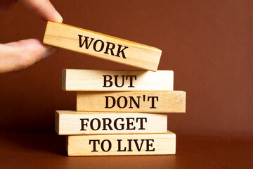 Wooden blocks with words 'Work But Don't Forget to Live'. Business concept
