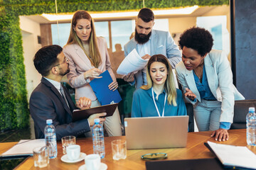 Team brainstorming. Group of business people working together on a laptop