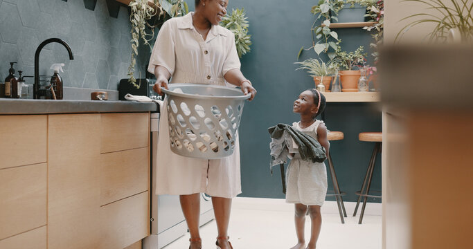 Laundry, Mother And Child Helping With Folding Of Clothes Together In A House. Happy, Excited And Young Girl Giving Help To Her Mom While Cleaning Clothing From A Washing Machine In Their Home