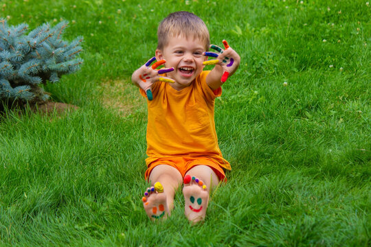 a smile painted with paints on the child's arms and legs.