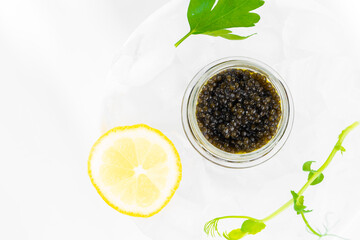 Appetizers of natural sturgeon black caviar, lemon and parsley