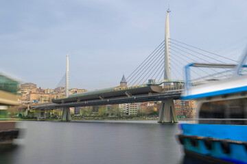 Long exposure. View of Haliç Metro Bridge connecting Azapkapı (Beyoğlu) and Unkapanı (Fatih) (Halic Metro Bridge). blue sky Istanbul Turkey	