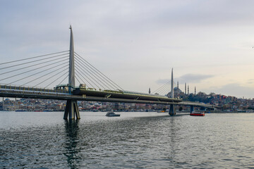 Fototapeta na wymiar Long exposure. View of Haliç Metro Bridge connecting Azapkapı (Beyoğlu) and Unkapanı (Fatih) (Halic Metro Bridge). blue sky Istanbul Turkey 