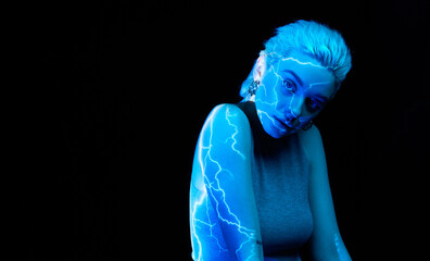 Lightening. Portrait of young blonde girl with abstract neon stripes on body posing over dark...