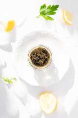 Appetizers of natural sturgeon black caviar, lemon and parsley