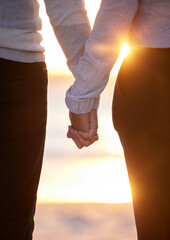 Back of couple holding hands at beach, sunset and vacation of save the date marriage. Closeup hand of man, woman and walking in sunshine, relax and trust of support, peace and love, travel or freedom