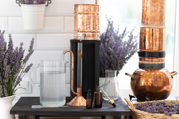 Distillation of lavender essential oil. Copper alambic in a Scandinavian interior. Chemical laboratory