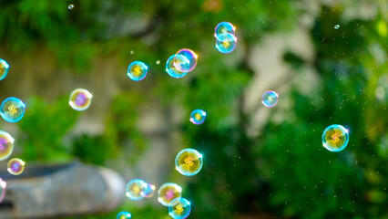 children playing with soap bubbles on summer vacation,toninf background