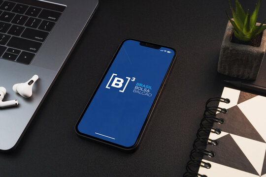 B3 stock exchange app stock exchange on the smartphone screen on black background table. Office environment. Rio de Janeiro, RJ, Brazil. February 2023