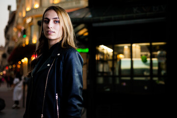 Woman wearing casual clothes walking in warm autumn evening city