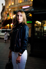 Woman wearing casual clothes walking in warm autumn evening city