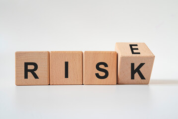 Risk and Rise text on wooden block. risk concept idea.
