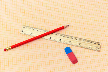 On the millimeter paper lie a ruler, a simple pencil and an eraser
