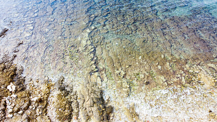 Rocky beach with blue sea at Cisterna Beach near Rovinj