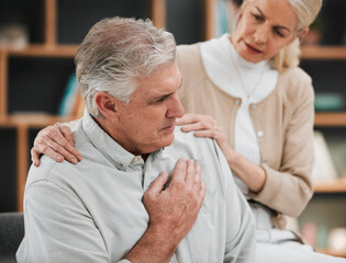 Heart attack, pain and senior couple at home with cardiology problem or stroke. House, cardiac...