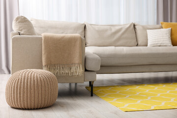 Spring atmosphere. Comfy sofa near ottoman in room