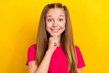 Fototapeta na wymiar Photo of good mood lovely nice schoolgirl with straight hairdo wear pink t-shirt finger touch chin isolated on yellow color background