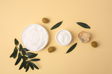 Obraz na płótnie Canvas Natural cosmetic. Different olive creams, mineral and ingredient on beige background, flat lay