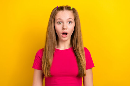 Photo of impressed astonished schoolgirl with straight hairstyle wear pink t-shirt staring at discount isolated on yellow color background