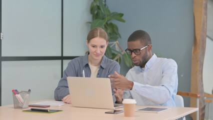 Young Business People Discussing Work in Office
