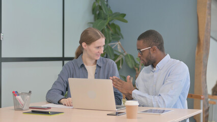 Mixed Race Young Business People Discussing Work, Paperwork