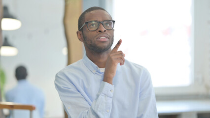 Fototapeta premium Portrait of Brainstorming African Man with an Idea