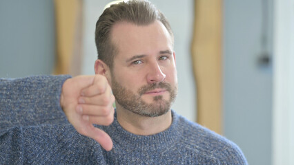 Obraz premium Portrait of Mature Adult Man showing Thumbs Down
