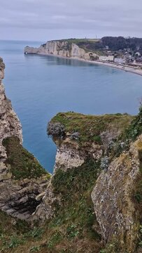 Wonderful vertical view to the Etretat village and beach resort from the famous Falaise d'Aval cliffs in Normandy, France
