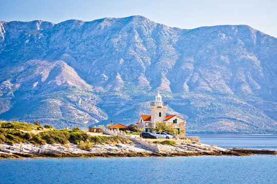Lighthouse of Sucuraj on Hvar island and Biokovo mountain background view