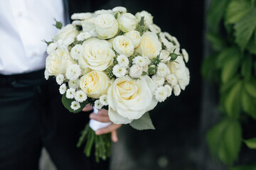 close-up wedding bouquet, bride's bouquet in the hands of the groom.Wedding accessories from natural flowers. Wedding day