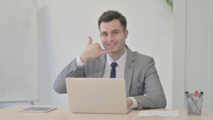 Call Me Gesture by Young Businessman Pointing at the Camera at Work