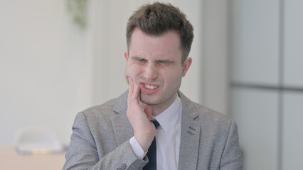 Portrait of Young Businessman with Toothache