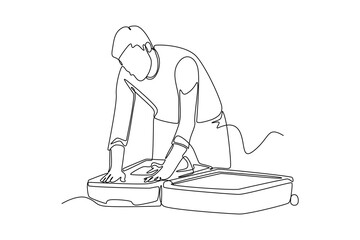 Continuous one line drawing  businessman packing his clothes in an opened suitcase. Travel experience concept. Single line draw design vector graphic illustration.