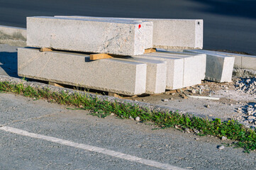 Curb stone for road repairs. Repair of the roadway. Material for road repairs.