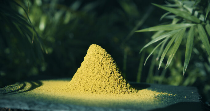 Kratom Powder on black stone in Bali Indonesia forrest