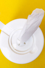Disinfectant wipes in packaging on yellow background closeup