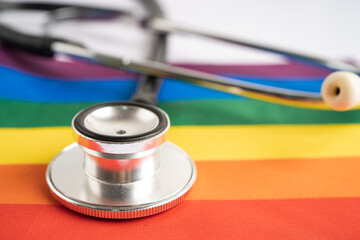 Black stethoscope on rainbow flag background, symbol of LGBT pride month celebrate annual in June social, symbol of gay, lesbian, bisexual, transgender, human rights and peace.