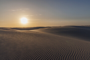 Fototapeta na wymiar Por do Sol nos Lençóis Maranhenses com sombra nas dunas na região da Lagoa Bonita