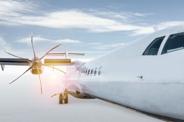 Close-up of white passenger turboprop airplane isolated on bright background with sky