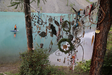 Unusual decorative ornaments made by tourists on a background of mountain lake