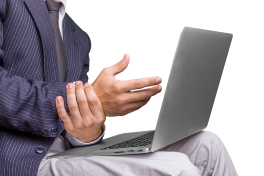 Human with wrist pain and working on laptop