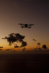 Fototapeta na wymiar Flying drone in a sunset sky.
