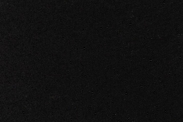 Water drops on dark stone