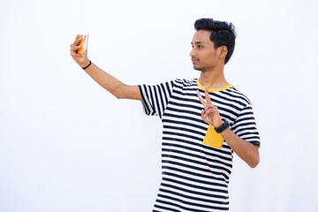 Man Taking a Selfie and Showing Sign of victory or peace expression on a white background