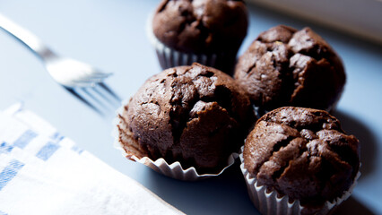 Chocolate muffins with chocolate chips inside.
