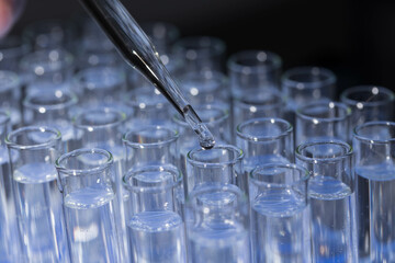 Pipette dropping fluid into test tube