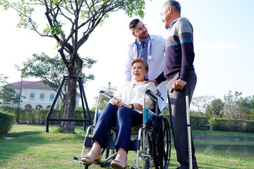 Male doctor caring for an elderly patient in a wheelchair concept of caring for the elderly.