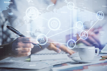 Double exposure of social network theme drawing over people taking notes background. Concept of human connection