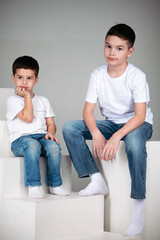 Two boys sitting together in studio